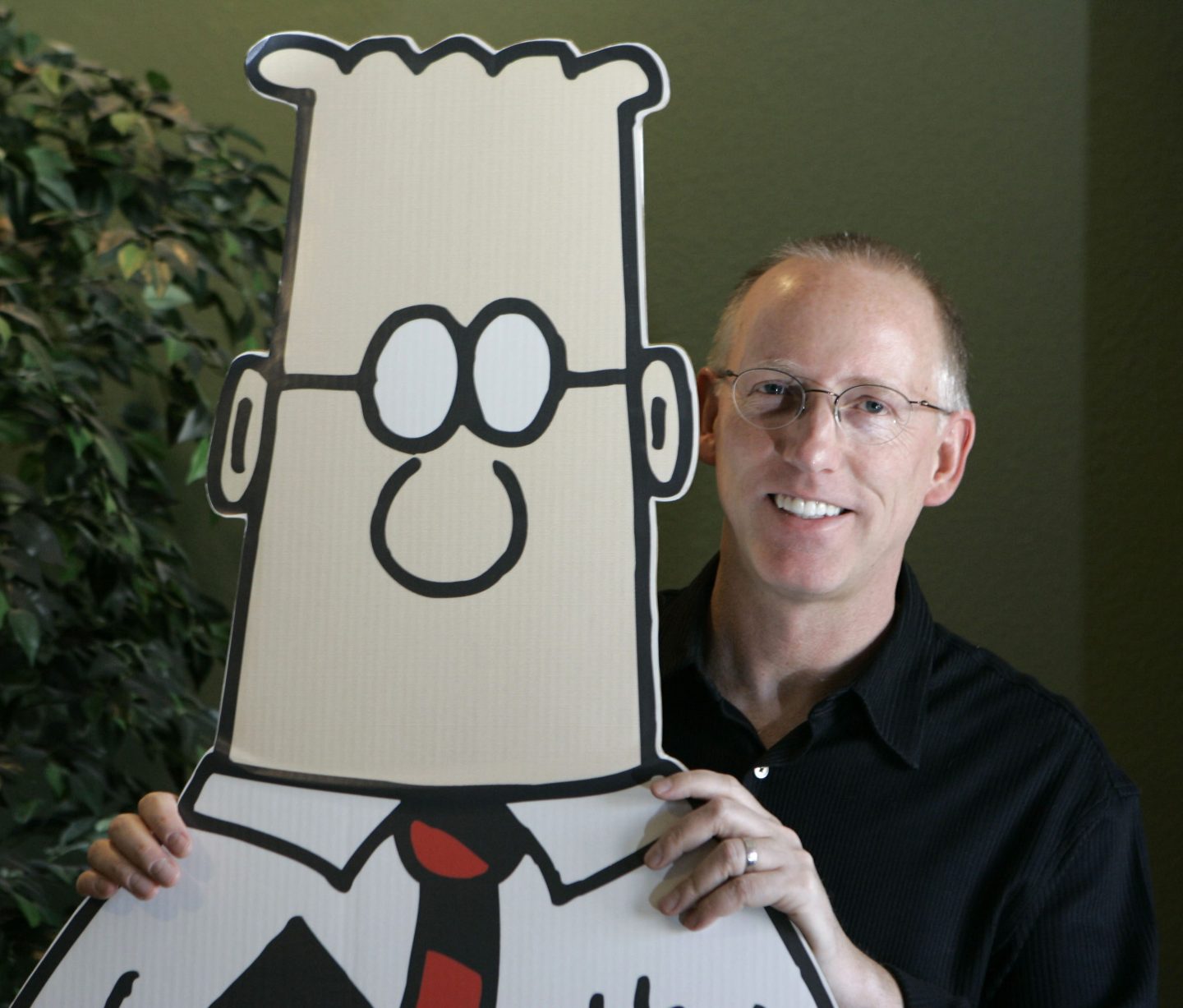 FLE &#8211; Scott Adams, creator of the comic strip Dilbert, poses for a portrait with the Dilbert character in his studio in Dublin, Calif., Oct. 26, 2006. Several prominent media publishers across the U.S. are dropping the Dilbert comic strip after Adams, its creator, described people who are Black as members of “a racist hate group” during an online video show. (AP Photo/Marcio Jose Sanchez, File)