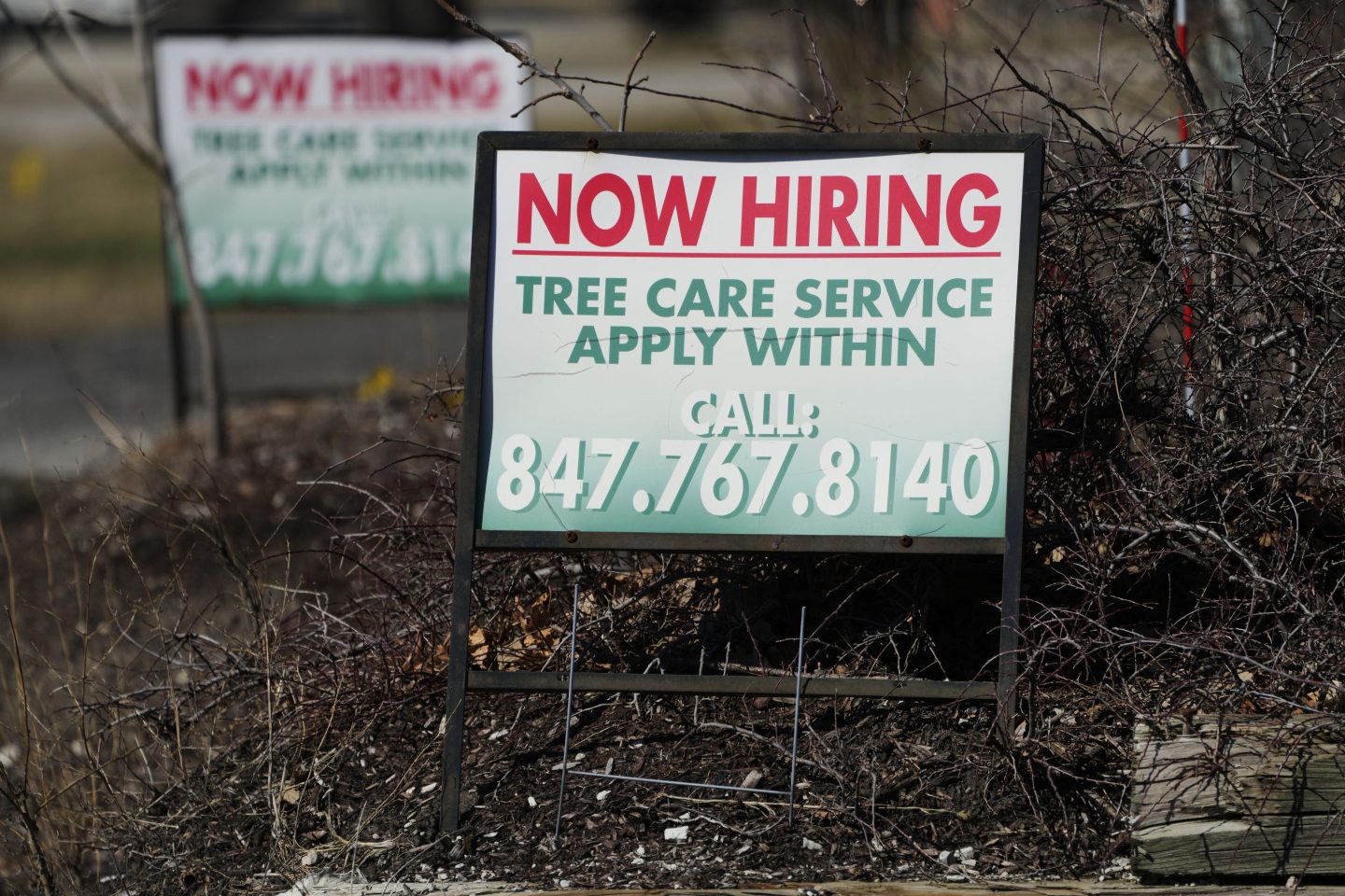 A hiring sign for tree care service work is posted in Wheeling, Ill., Sunday, March 19, 2023. On Thursday, the Labor Department reports on the number of people who applied for unemployment benefits last week. (AP Photo/Nam Y. Huh)