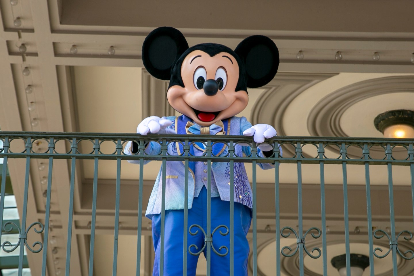 FILE &#8211; An actor dressed as Mickey Mouse greets visitors at the entrance to Magic Kingdom Park at Walt Disney World Resort, April 18, 2022, in Lake Buena Vista, Fla. Winnie the Pooh and Mickey Mouse have recently entered the public domain, making it possible for artists to use them freely. (AP Photo/Ted Shaffrey, File)