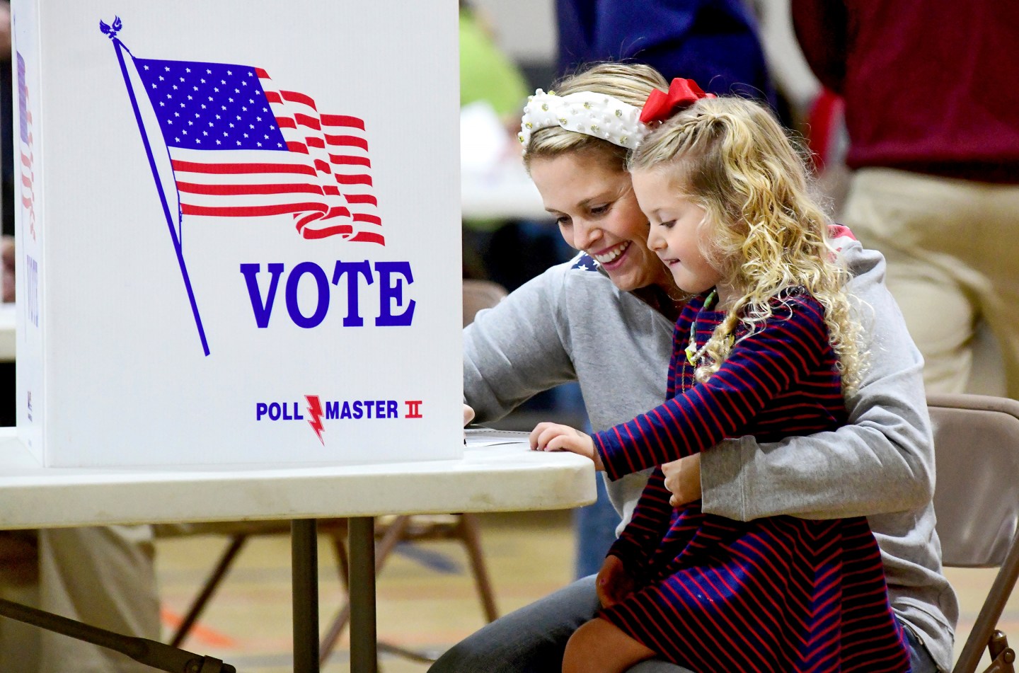 Kate Aurandt-Gribbler holds her daughter, Olivia Gribbler, 3, as she votes at the Westmont Borough No. 1 polling place at Westmont Grove in Johnstown, Pa., in<br />
Cambria County, on Tuesday, Nov. 5, 2024. (Thomas Slusser/The Tribune-Democrat via AP)