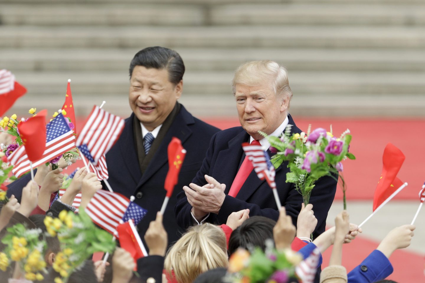 Trump and Xi greet a crowd of cheering people