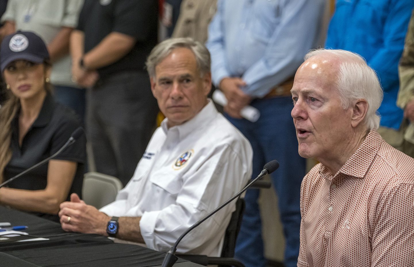 Sen. John Cornyn, right, speaks to media during a press conference as Homeland Security Secretary Kristi Noem, left, and Gov. Greg Abbott, center, listen after recent flooding along the Guadalupe River during a press conference on Saturday, July 5, 2025, in Kerrville, Texas. (AP Photo/Rodolfo Gonzalez)
