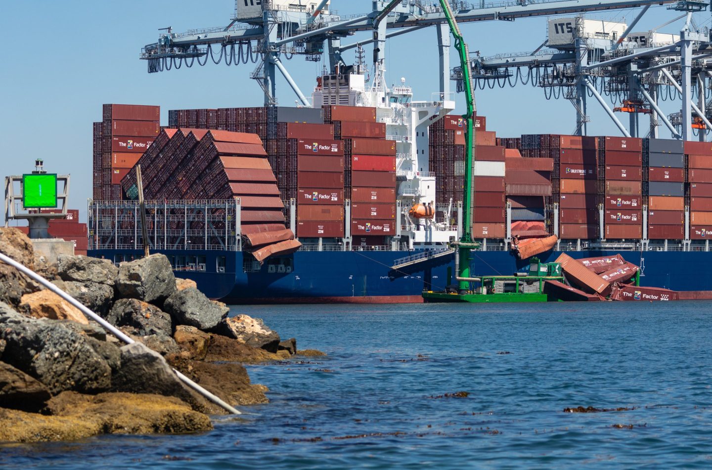 Fallen shipping containers in the water near the Mississippi container ship at the Port of Long Beach, in Long Beach, California, US, on Tuesday, Sept. 9, 2025. Cargo handling operations are suspended as responders work to secure dozens of containers that fell from the vessel berthed at a Port of Long Beach terminal Tuesday morning. Photographer: Tim Rue/Bloomberg via Getty Images