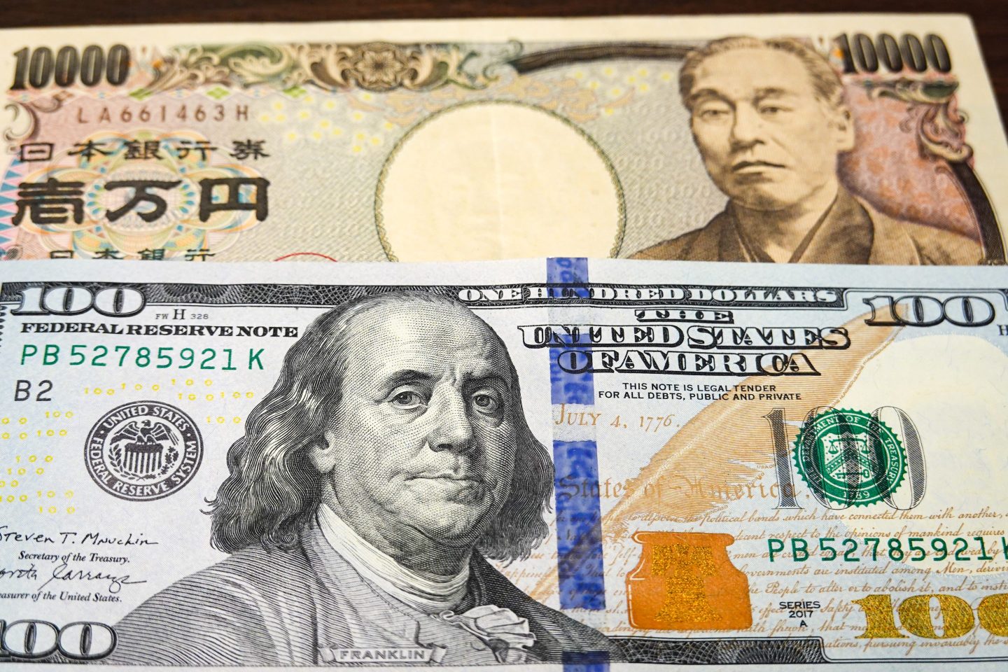 CHINA &#8211; 2025/09/29: In this photo illustration, a 100 dollar bill seen displayed below a 10,000 yen note. (Photo Illustration by Sheldon Cooper/SOPA Images/LightRocket via Getty Images)